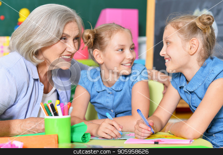 To use this stock image in your creative project, please select the size you need over to the right and click the "Add to Cart" button.
Your downloaded image will come with the Cutcaster watermark removed so don’t worry about the watermark you see on this page. Grandmother with two adorable twin granddaughters stock photo, Grandmother with two adorable twin granddaughters drawing together by Ruslan Huzau