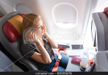 To use this stock image in your creative project, please select the size you need over to the right and click the "Add to Cart" button.
Your downloaded image will come with the Cutcaster watermark removed so don’t worry about the watermark you see on this page. Woman flying on commercial passengers airplane, listening to music. stock photo, Woman flying on commercial passengers airplane, drinking coffee, listening to music. by kasto