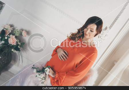To use this stock image in your creative project, please select the size you need over to the right and click the "Add to Cart" button.
Your downloaded image will come with the Cutcaster watermark removed so don’t worry about the watermark you see on this page. pregnant woman in red dress sitting on chair and stroking her belly stock photo, pregnant woman in red dress sitting on chair and stroking her belly by aaalll3110