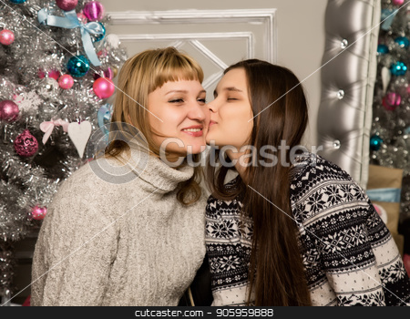To use this stock image in your creative project, please select the size you need over to the right and click the "Add to Cart" button.
Your downloaded image will come with the Cutcaster watermark removed so don’t worry about the watermark you see on this page. happy mother and teenag daughter near christmas tree at home laugh and hug stock photo, happy mother and teenag daughter near christmas tree at home laugh and hug. by Alexander