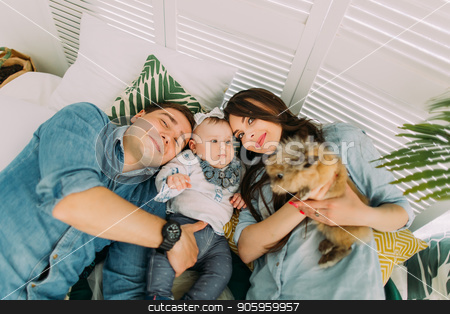 To use this stock image in your creative project, please select the size you need over to the right and click the "Add to Cart" button.
Your downloaded image will come with the Cutcaster watermark removed so don’t worry about the watermark you see on this page. The close-up portrait of the happy family lying with the kid and rabbit on the bed. Above view. stock photo, The close-up portrait of the happy family lying with the kid and rabbit on the bed. Above view by Andrii Kobryn