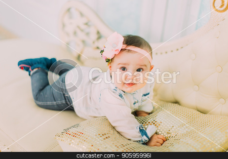 To use this stock image in your creative project, please select the size you need over to the right and click the "Add to Cart" button.
Your downloaded image will come with the Cutcaster watermark removed so don’t worry about the watermark you see on this page. The front portrait of the little baby with the bow and flowers on the head lying on the white sofa. stock photo, The front portrait of the little baby with the bow and flowers on the head lying on the white sofa by Andrii Kobryn