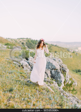 To use this stock image in your creative project, please select the size you need over to the right and click the "Add to Cart" button.
Your downloaded image will come with the Cutcaster watermark removed so don’t worry about the watermark you see on this page. The full-length view of the bride touching her hair and looking aside at the backgroud of the mountains. stock photo, The full-length view of the bride touching her hair and looking aside at the backgroud of the mountains by Andrii Kobryn