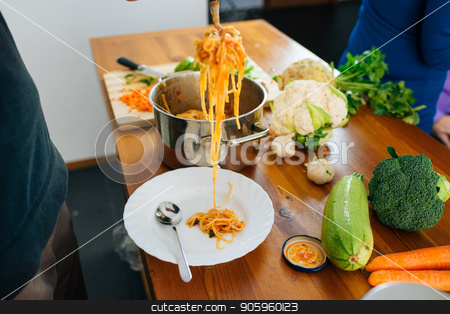 To use this stock image in your creative project, please select the size you need over to the right and click the "Add to Cart" button.
Your downloaded image will come with the Cutcaster watermark removed so don’t worry about the watermark you see on this page. Preparing an Italian Food stock photo, Close View of Woman Preparing a Delicious Spaghetti in The Kitchen. Healthy Food Concept. by Vera Arsic
