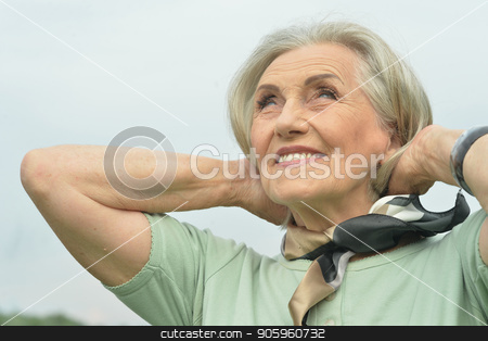 To use this stock image in your creative project, please select the size you need over to the right and click the "Add to Cart" button.
Your downloaded image will come with the Cutcaster watermark removed so don’t worry about the watermark you see on this page. smiling elderly woman stock photo, Portrait of happy smiling elderly woman posing outdoors by Ruslan Huzau