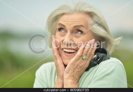 To use this stock image in your creative project, please select the size you need over to the right and click the "Add to Cart" button.
Your downloaded image will come with the Cutcaster watermark removed so don’t worry about the watermark you see on this page. smiling elderly woman stock photo, Portrait of happy smiling elderly woman posing outdoors by Ruslan Huzau