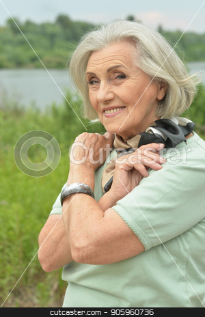To use this stock image in your creative project, please select the size you need over to the right and click the "Add to Cart" button.
Your downloaded image will come with the Cutcaster watermark removed so don’t worry about the watermark you see on this page. smiling elderly woman stock photo, Portrait of happy smiling elderly woman posing outdoors by Ruslan Huzau
