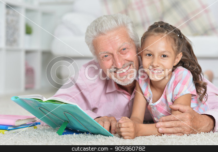 To use this stock image in your creative project, please select the size you need over to the right and click the "Add to Cart" button.
Your downloaded image will come with the Cutcaster watermark removed so don’t worry about the watermark you see on this page. Father helping son with homework stock photo, Grandfather helping his granddaughter to do homework at home by Ruslan Huzau