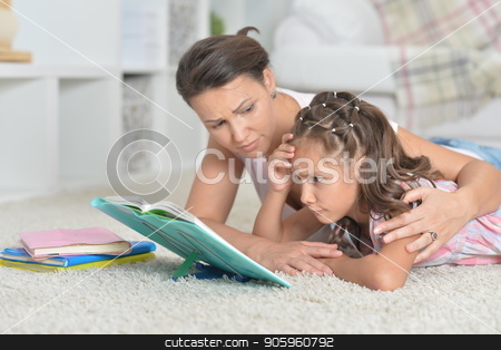 To use this stock image in your creative project, please select the size you need over to the right and click the "Add to Cart" button.
Your downloaded image will come with the Cutcaster watermark removed so don’t worry about the watermark you see on this page. Mother with daughter doing homework stock photo, Close-up portrait of mother with daughter doing homework by Ruslan Huzau