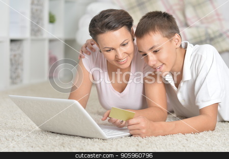To use this stock image in your creative project, please select the size you need over to the right and click the "Add to Cart" button.
Your downloaded image will come with the Cutcaster watermark removed so don’t worry about the watermark you see on this page. mother and son using laptop, online shopping concept stock photo, Portrait of mother and son using laptop, online shopping concept by Ruslan Huzau