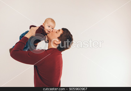 To use this stock image in your creative project, please select the size you need over to the right and click the "Add to Cart" button.
Your downloaded image will come with the Cutcaster watermark removed so don’t worry about the watermark you see on this page. Adult man giving a kiss to his baby raised in his arms. stock photo, Adult man giving a kiss to his baby raised in his arms. by aaalll3110