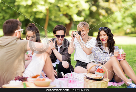 To use this stock image in your creative project, please select the size you need over to the right and click the "Add to Cart" button.
Your downloaded image will come with the Cutcaster watermark removed so don’t worry about the watermark you see on this page. friends with camera photographing at summer picnic stock photo, friendship, leisure and technology concept - group of happy smiling friends with non alcoholic drinks photographing by vintage camera at picnic in summer park by Syda Productions