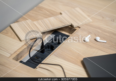 To use this stock image in your creative project, please select the size you need over to the right and click the "Add to Cart" button.
Your downloaded image will come with the Cutcaster watermark removed so don’t worry about the watermark you see on this page. Closeup photo of wooden table with power sockets stock photo, Black power sockets built-in the light wooden table on the gray wall background. On the table there is a laptop with a power cable and white wireless earphones. Closeup. Horizontal. by bezikus