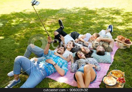 To use this stock image in your creative project, please select the size you need over to the right and click the "Add to Cart" button.
Your downloaded image will come with the Cutcaster watermark removed so don’t worry about the watermark you see on this page. friends taking picture by selfie stick at picnic stock photo, friendship, leisure and technology concept - group of happy smiling friends taking picture by selfie stick chilling on picnic blanket at summer park by Syda Productions