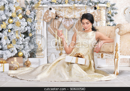 To use this stock image in your creative project, please select the size you need over to the right and click the "Add to Cart" button.
Your downloaded image will come with the Cutcaster watermark removed so don’t worry about the watermark you see on this page. Portrait of beautiful young woman posing in room stock photo, Portrait of beautiful young woman posing in room decorated to Christmas holiday by Ruslan Huzau
