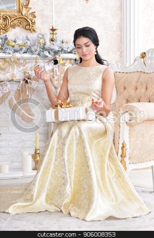 To use this stock image in your creative project, please select the size you need over to the right and click the "Add to Cart" button.
Your downloaded image will come with the Cutcaster watermark removed so don’t worry about the watermark you see on this page. Portrait of beautiful young woman posing in room stock photo, Portrait of beautiful young woman posing in room decorated to Christmas holiday by Ruslan Huzau