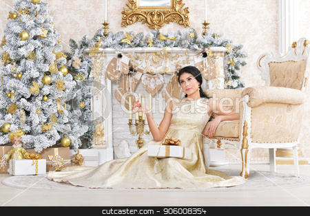To use this stock image in your creative project, please select the size you need over to the right and click the "Add to Cart" button.
Your downloaded image will come with the Cutcaster watermark removed so don’t worry about the watermark you see on this page. Portrait of beautiful young woman posing in room stock photo, Portrait of beautiful young woman posing in room decorated to Christmas holiday by Ruslan Huzau