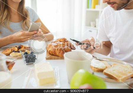 To use this stock image in your creative project, please select the size you need over to the right and click the "Add to Cart" button.
Your downloaded image will come with the Cutcaster watermark removed so don’t worry about the watermark you see on this page. close up of couple with smartphones at breakfast stock photo, food and technology concept - close up of couple with smartphones having breakfast at home by Syda Productions