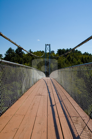 To use this stock image in your creative project, please select the size you need over to the right and click the "Add to Cart" button.
Your downloaded image will come with the Cutcaster watermark removed so don’t worry about the watermark you see on this page. Long Pedestrian Bridge stock photo, Long bridge crossing a river in Coaticook canada by Jean Larue-Frechette
