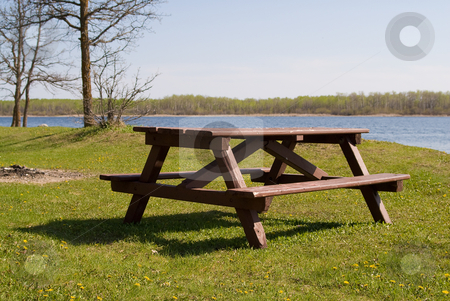 To use this stock image in your creative project, please select the size you need over to the right and click the "Add to Cart" button.
Your downloaded image will come with the Cutcaster watermark removed so don’t worry about the watermark you see on this page. Picnic Table stock photo, A wooden picnic table placed near a small lake by Richard Nelson