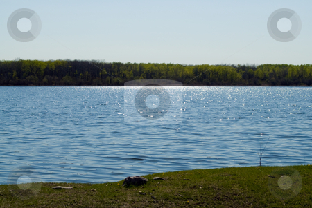 To use this stock image in your creative project, please select the size you need over to the right and click the "Add to Cart" button.
Your downloaded image will come with the Cutcaster watermark removed so don’t worry about the watermark you see on this page. Small Lake stock photo, Landscape view of a small lake with the sun shimmering on the water by Richard Nelson