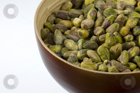 To use this stock image in your creative project, please select the size you need over to the right and click the "Add to Cart" button.
Your downloaded image will come with the Cutcaster watermark removed so don’t worry about the watermark you see on this page. Shelled pistachio nuts stock photo, A wooden bowl of shelled pistachio nuts against white background by Marek Uliasz