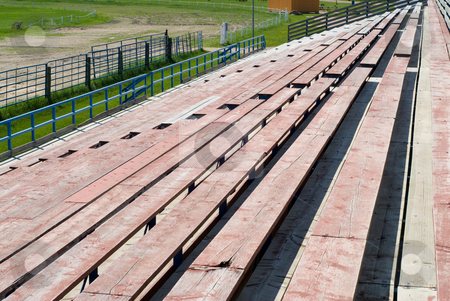 To use this stock image in your creative project, please select the size you need over to the right and click the "Add to Cart" button.
Your downloaded image will come with the Cutcaster watermark removed so don’t worry about the watermark you see on this page. Bleachers stock photo, View of a set of bleachers from the top level by Richard Nelson