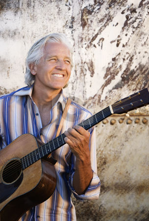 To use this stock image in your creative project, please select the size you need over to the right and click the "Add to Cart" button.
Your downloaded image will come with the Cutcaster watermark removed so don’t worry about the watermark you see on this page. Guitar Player stock photo, Guitar player with his instrument in golden light by Scott Griessel