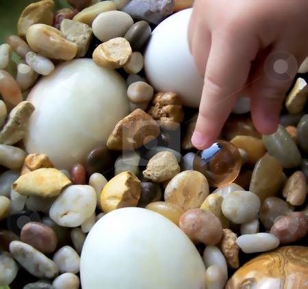 To use this stock image in your creative project, please select the size you need over to the right and click the "Add to Cart" button.
Your downloaded image will come with the Cutcaster watermark removed so don’t worry about the watermark you see on this page. Young Child Reaching for Pebble, with Stone Eggs stock photo, by Jill Oliver