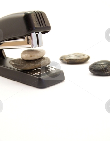 To use this stock image in your creative project, please select the size you need over to the right and click the "Add to Cart" button.
Your downloaded image will come with the Cutcaster watermark removed so don’t worry about the watermark you see on this page. Super Stapler, Vertical stock photo, Image of a black stapler about to staple two stones together. Other stones are nearby. Vertical orientation. by Jill Oliver