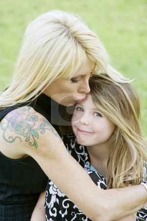 To use this stock image in your creative project, please select the size you need over to the right and click the "Add to Cart" button.
Your downloaded image will come with the Cutcaster watermark removed so don’t worry about the watermark you see on this page. Mother and Daughter stock photo, Pretty mom hugs and kisses her cute freckle-faced daughter by Scott Griessel