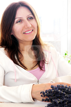 To use this stock image in your creative project, please select the size you need over to the right and click the "Add to Cart" button.
Your downloaded image will come with the Cutcaster watermark removed so don’t worry about the watermark you see on this page. Mature woman relaxing stock photo, Smiling mature woman relaxing at home holding a cup by Elena Elisseeva