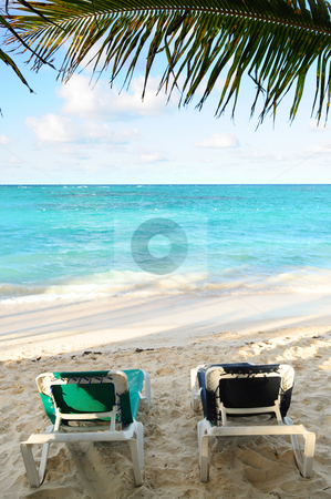 To use this stock image in your creative project, please select the size you need over to the right and click the "Add to Cart" button.
Your downloaded image will come with the Cutcaster watermark removed so don’t worry about the watermark you see on this page. Beach chairs on ocean shore stock photo, Two beach chairs under a palm tree on the ocean shore in tropical resort by Elena Elisseeva