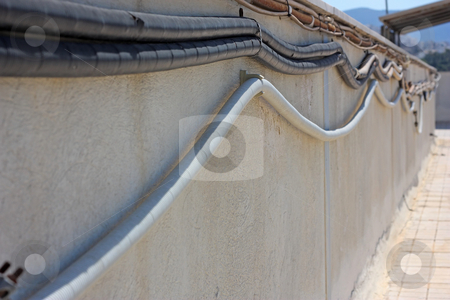 To use this stock image in your creative project, please select the size you need over to the right and click the "Add to Cart" button.
Your downloaded image will come with the Cutcaster watermark removed so don’t worry about the watermark you see on this page. Outside Electrical Cabling stock photo, Protected electrical cables along a roof wall (focus on the first curve of the lower cable) by Georgios Alexandris