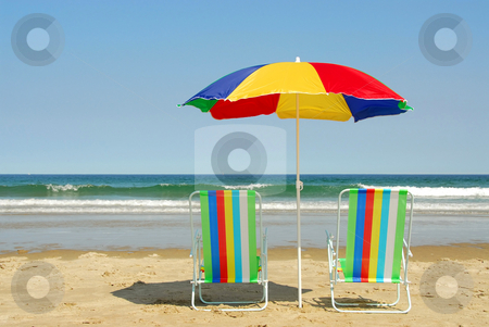 To use this stock image in your creative project, please select the size you need over to the right and click the "Add to Cart" button.
Your downloaded image will come with the Cutcaster watermark removed so don’t worry about the watermark you see on this page. Beach chairs and umbrella stock photo, Beach chairs and umbrella on the ocean shore with surf in the background, horisontal by Elena Elisseeva