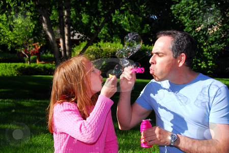 To use this stock image in your creative project, please select the size you need over to the right and click the "Add to Cart" button.
Your downloaded image will come with the Cutcaster watermark removed so don’t worry about the watermark you see on this page. Family summer bubbles stock photo, Happy family blowing soap bubbles, father and child by Elena Elisseeva