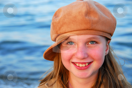 To use this stock image in your creative project, please select the size you need over to the right and click the "Add to Cart" button.
Your downloaded image will come with the Cutcaster watermark removed so don’t worry about the watermark you see on this page. Smiling girl in a hat stock photo, Cute preteen girl smiling wearing suede hat, blue water background by Elena Elisseeva