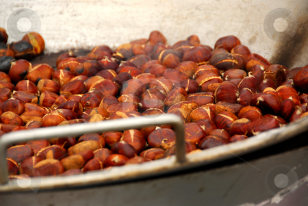 To use this stock image in your creative project, please select the size you need over to the right and click the "Add to Cart" button.
Your downloaded image will come with the Cutcaster watermark removed so don’t worry about the watermark you see on this page. Roasting chestnuts stock photo, Chestnuts roasting in a pan at street vendor's stand by Elena Elisseeva