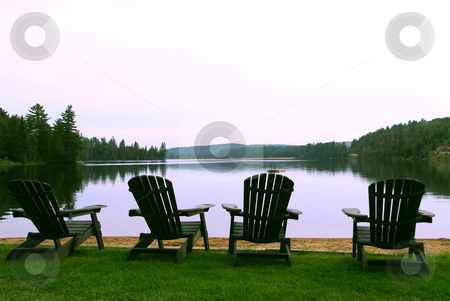 To use this stock image in your creative project, please select the size you need over to the right and click the "Add to Cart" button.
Your downloaded image will come with the Cutcaster watermark removed so don’t worry about the watermark you see on this page. Four Lake chairs stock photo, Four wooden adirondack chairs on a shore of a beautiful lake at dusk by Elena Elisseeva