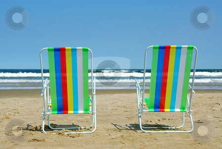 To use this stock image in your creative project, please select the size you need over to the right and click the "Add to Cart" button.
Your downloaded image will come with the Cutcaster watermark removed so don’t worry about the watermark you see on this page. Vacation paradise stock photo, Two colorful beach chairs on the ocean shore by Elena Elisseeva