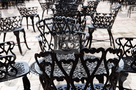To use this stock image in your creative project, please select the size you need over to the right and click the "Add to Cart" button.
Your downloaded image will come with the Cutcaster watermark removed so don’t worry about the watermark you see on this page. Wrought iron furniture stock photo, Wrought iron furniture on the outdoor cafe patio by Elena Elisseeva