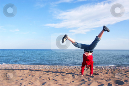 To use this stock image in your creative project, please select the size you need over to the right and click the "Add to Cart" button.
Your downloaded image will come with the Cutcaster watermark removed so don’t worry about the watermark you see on this page. Girl doing cartwheel stock photo, Young girl doing cartwheel on a beach by Elena Elisseeva
