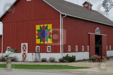 To use this stock image in your creative project, please select the size you need over to the right and click the "Add to Cart" button.
Your downloaded image will come with the Cutcaster watermark removed so don’t worry about the watermark you see on this page. Barn Quilt on Old Iowa Barn stock photo, Barn Quilts are making an appearance on old barns in Iowa and other farm states. They are generally 8'x 8