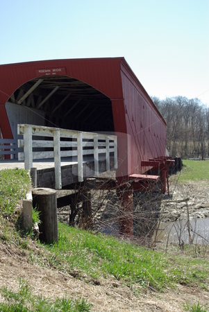 To use this stock image in your creative project, please select the size you need over to the right and click the "Add to Cart" button.
Your downloaded image will come with the Cutcaster watermark removed so don’t worry about the watermark you see on this page. Roseman Covered Bridge stock photo, The Roseman Bridge (built in 1883) is a popular tourist attraction for visitors to the sleepy town of Winterset, Iowa. The covered bridges in south central Iowa, not far from Des Moines, gained fame from the popularity of the movie and book,