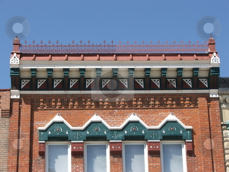 To use this stock image in your creative project, please select the size you need over to the right and click the "Add to Cart" button.
Your downloaded image will come with the Cutcaster watermark removed so don’t worry about the watermark you see on this page. Unique decorated old windows stock photo, Unique Italian and American architectural details and decorations grace these old double hung windows on a storefront in Winterset, Iowa. by Dennis Thomsen