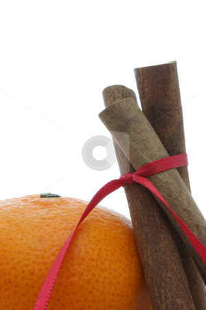 To use this stock image in your creative project, please select the size you need over to the right and click the "Add to Cart" button.
Your downloaded image will come with the Cutcaster watermark removed so don’t worry about the watermark you see on this page. Cinnamon stock photo, Three cinnamon sticks tied with a red ribbon, leaning against a mandarin orange, isolated on white. by Jessica Tooley