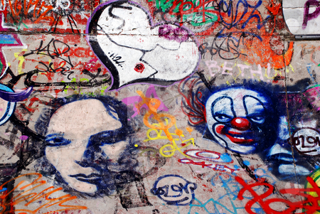 To use this stock image in your creative project, please select the size you need over to the right and click the "Add to Cart" button.
Your downloaded image will come with the Cutcaster watermark removed so don’t worry about the watermark you see on this page. Extensive Graffiti stock photo, A display of graffiti, including a heart, faces and a clown by Philippa Willitts