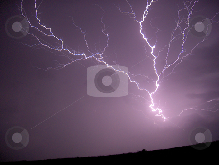 To use this stock image in your creative project, please select the size you need over to the right and click the "Add to Cart" button.
Your downloaded image will come with the Cutcaster watermark removed so don’t worry about the watermark you see on this page. Lightning Strike stock photo, A bolt of lightning on a dark stormy night. by Jessica Tooley
