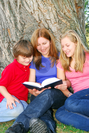 To use this stock image in your creative project, please select the size you need over to the right and click the "Add to Cart" button.
Your downloaded image will come with the Cutcaster watermark removed so don’t worry about the watermark you see on this page. Family reading a book stock photo, Family of mother and children reading a book under a tree in summer park by Elena Elisseeva