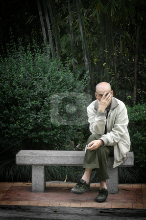To use this stock image in your creative project, please select the size you need over to the right and click the "Add to Cart" button.
Your downloaded image will come with the Cutcaster watermark removed so don’t worry about the watermark you see on this page. On a Bench stock photo, An elderly Chinese gentleman peeks through his fingers while sitting cross-legged on a stone bench. by Nathan Smith